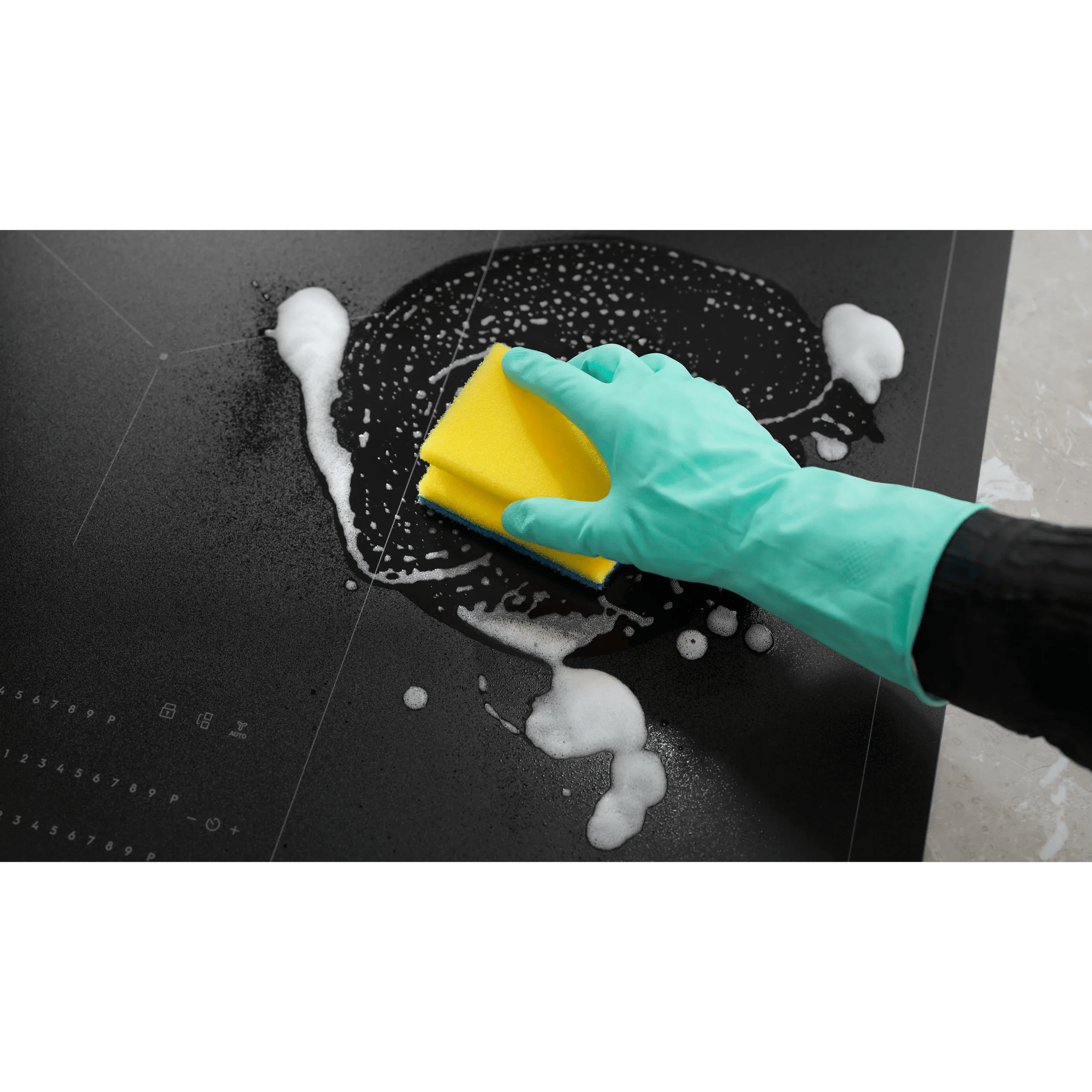 Hob Cleaner being applied with foam and sponge, highlighting its easy-to-clean feature.