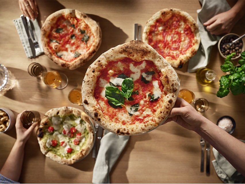 Top view of 4 pizzas.