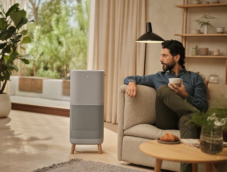 Man sitting near an air purifier
